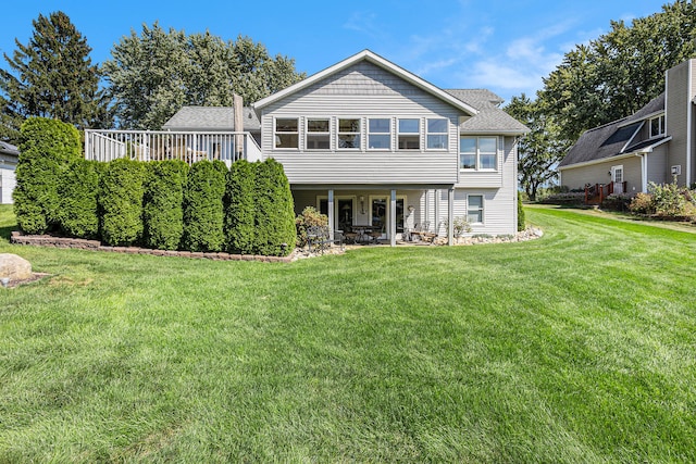 rear view of house with a yard