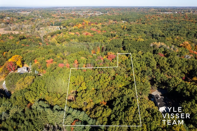 drone / aerial view with a wooded view