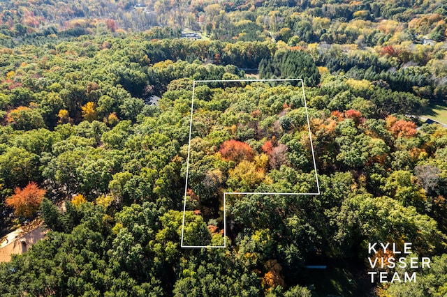 birds eye view of property with a view of trees