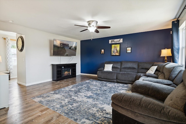 living room with hardwood / wood-style flooring and ceiling fan