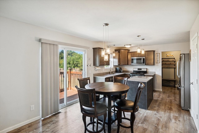 dining room featuring hardwood / wood-style flooring and sink