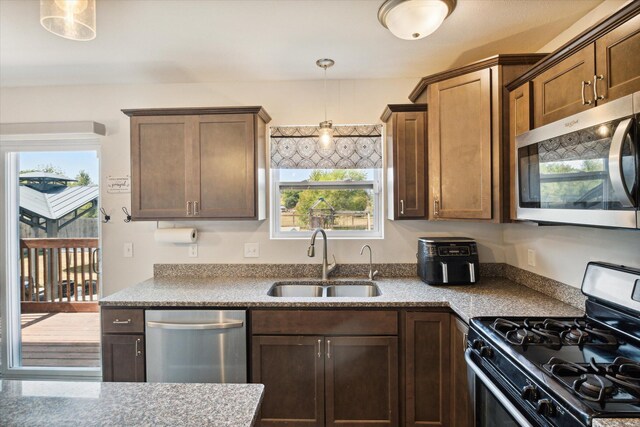 kitchen featuring pendant lighting, sink, a healthy amount of sunlight, and appliances with stainless steel finishes