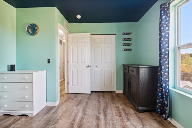 bedroom featuring a closet and light hardwood / wood-style floors