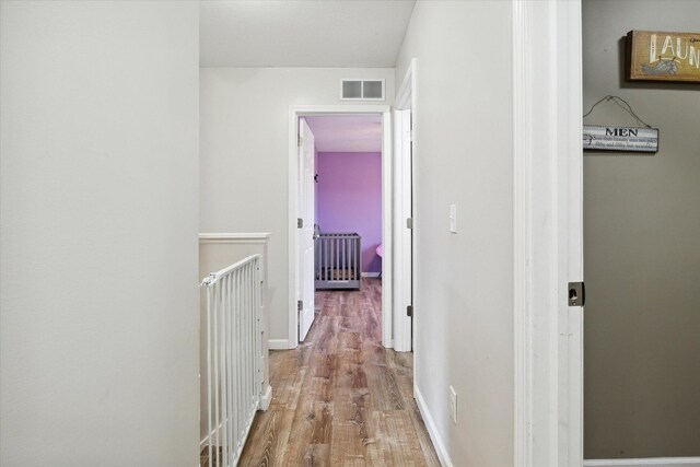 corridor with light hardwood / wood-style floors