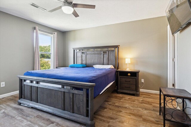 bedroom with hardwood / wood-style floors and ceiling fan