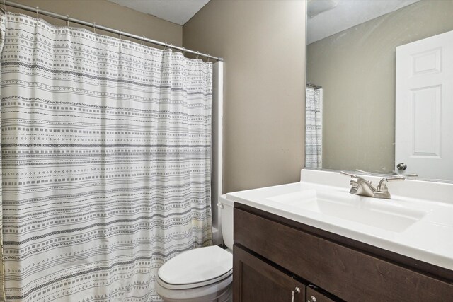 full bathroom with vanity, toilet, and shower / tub combo