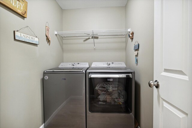 clothes washing area featuring washing machine and clothes dryer