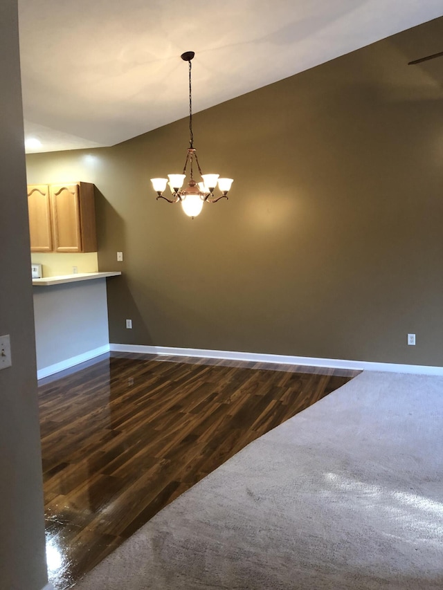 interior space with a notable chandelier and dark hardwood / wood-style floors