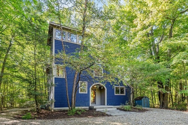 view of front of house with a storage unit