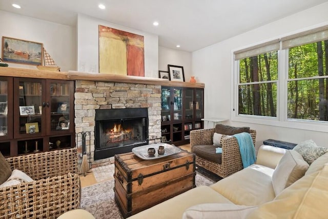 living room with a fireplace and light wood-type flooring