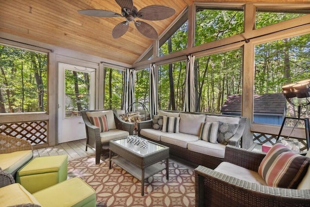 sunroom / solarium with vaulted ceiling, ceiling fan, and wood ceiling