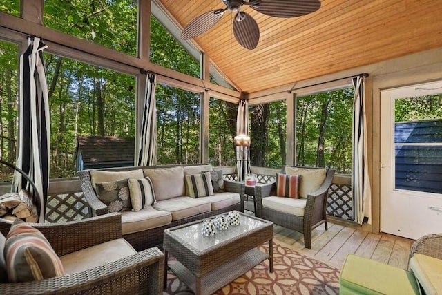 sunroom / solarium featuring vaulted ceiling, ceiling fan, and wooden ceiling