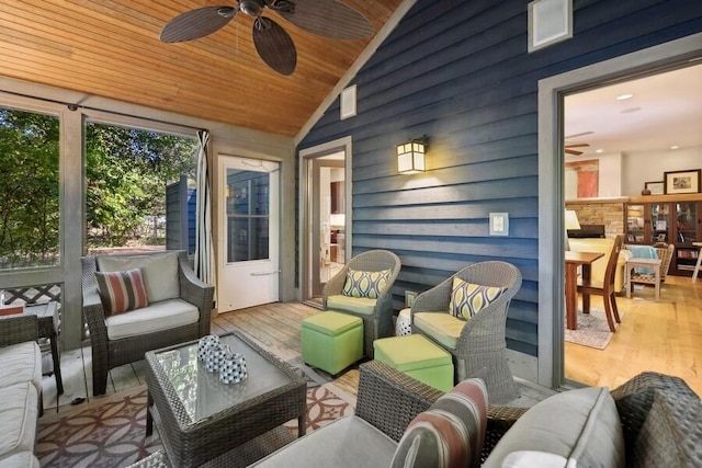 sunroom / solarium with vaulted ceiling, ceiling fan, and wood ceiling