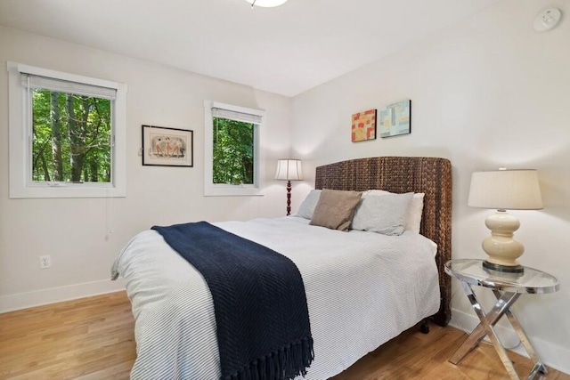 bedroom featuring light hardwood / wood-style floors and multiple windows