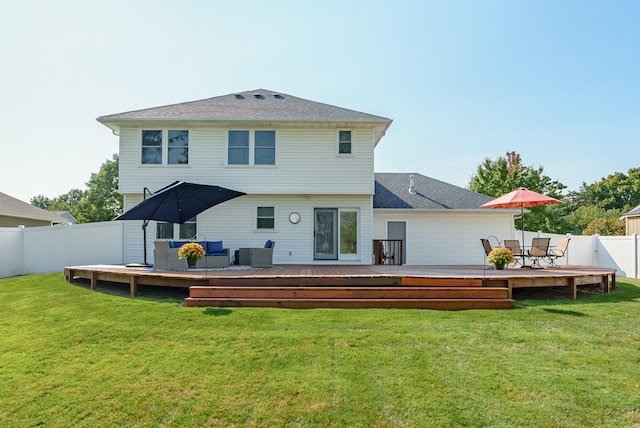 rear view of property with cooling unit, a yard, and a wooden deck