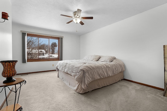 bedroom featuring ceiling fan and light colored carpet