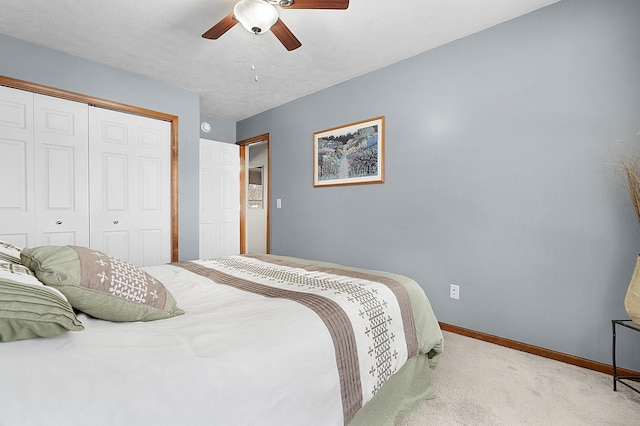 bedroom with a closet, ceiling fan, and light colored carpet