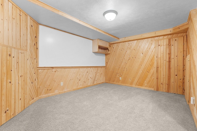 carpeted spare room with a textured ceiling