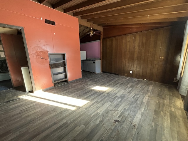 interior space with wood ceiling, dark hardwood / wood-style floors, wood walls, lofted ceiling with beams, and ceiling fan