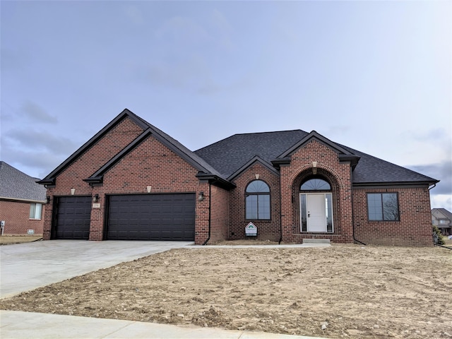 view of front of property with brick siding, driveway, an attached garage, and a shingled roof