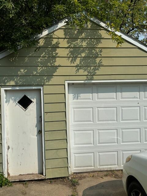 garage featuring wood walls