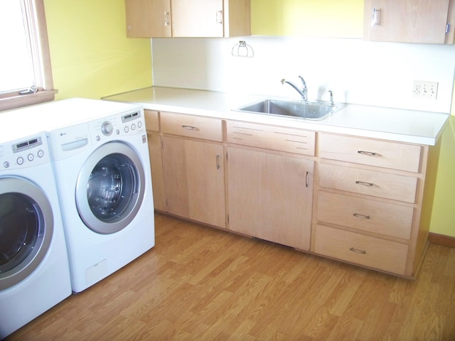 laundry room featuring cabinets, sink, independent washer and dryer, and light wood-type flooring