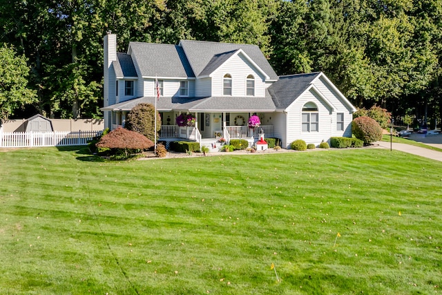 view of front of house with a front yard and covered porch