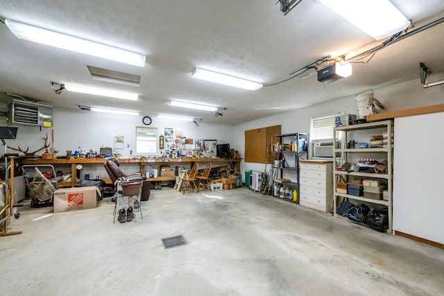 garage with a workshop area and a garage door opener