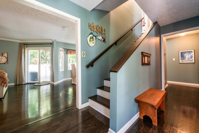 stairs featuring wood-type flooring and a textured ceiling