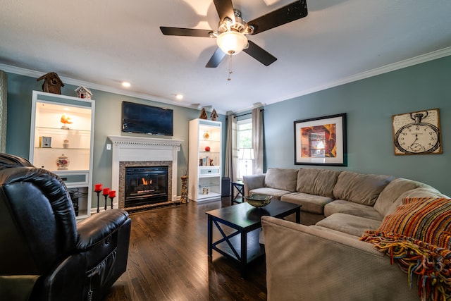 living room with ceiling fan, ornamental molding, a premium fireplace, and dark hardwood / wood-style flooring