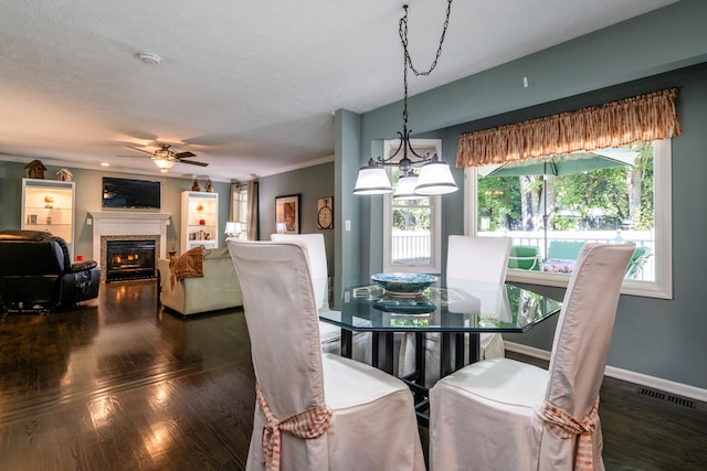 dining room featuring ceiling fan with notable chandelier, dark hardwood / wood-style floors, and a textured ceiling