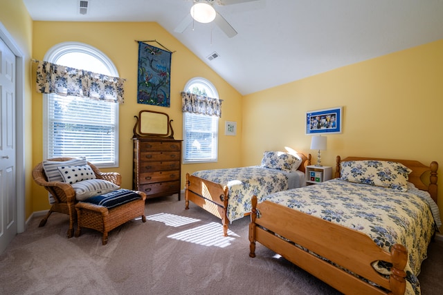 carpeted bedroom with ceiling fan, a closet, and vaulted ceiling