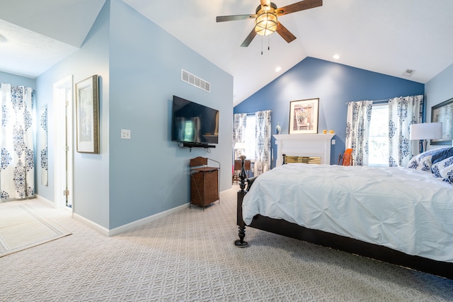 carpeted bedroom featuring ceiling fan and vaulted ceiling