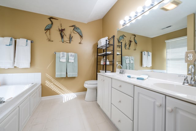 bathroom with vanity, a bathtub, and toilet