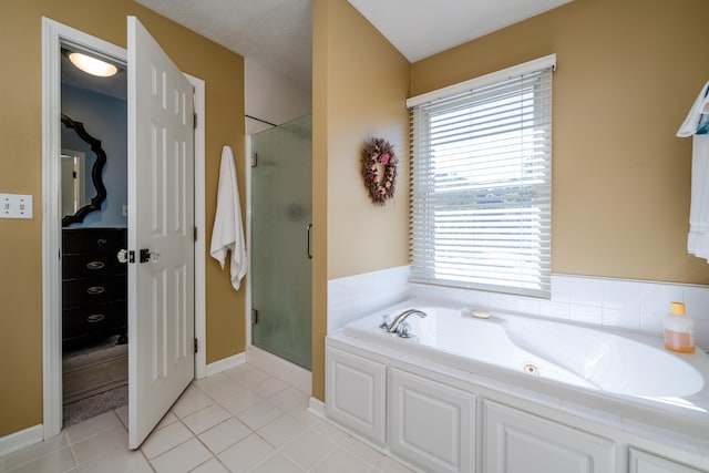 bathroom featuring separate shower and tub, a textured ceiling, and tile patterned floors