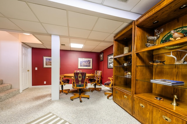 office space with a paneled ceiling and carpet flooring