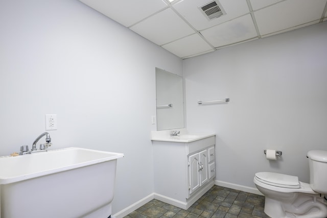 bathroom featuring a paneled ceiling, vanity, and toilet