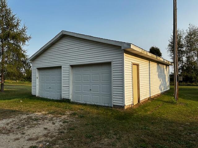 garage featuring a lawn