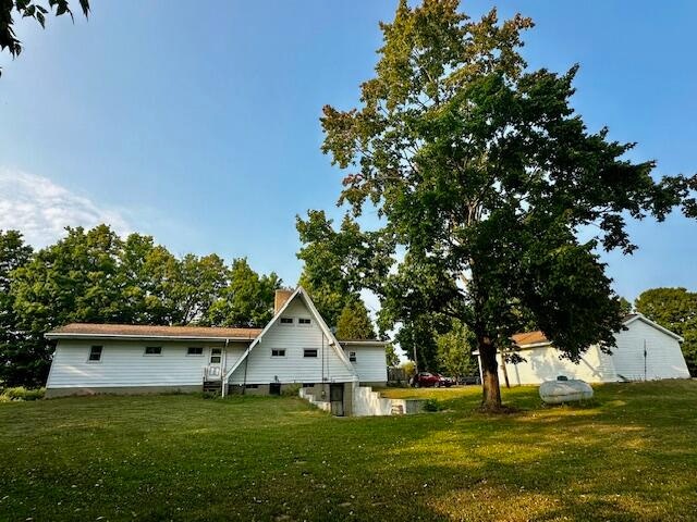 back of property with a lawn