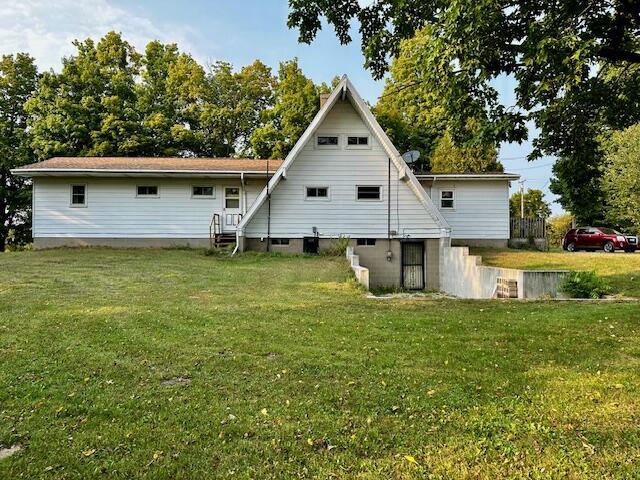 rear view of house with a yard