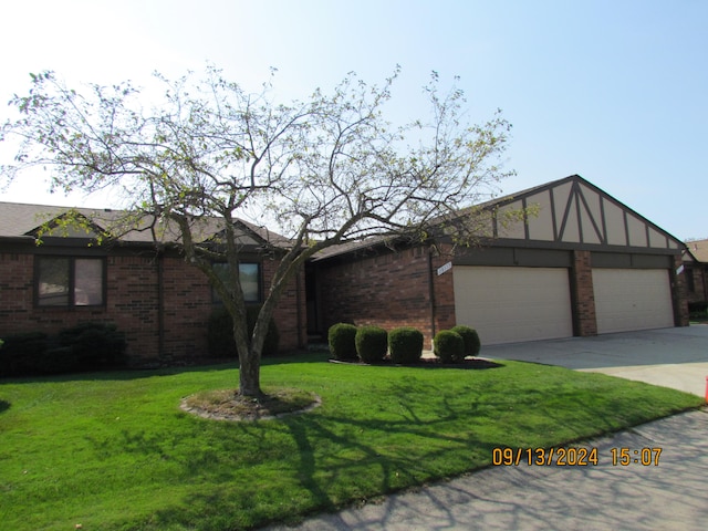 ranch-style house with a front yard and a garage