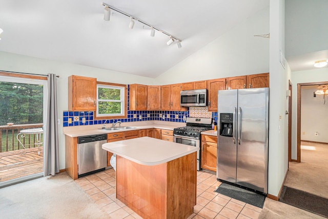 kitchen featuring vaulted ceiling, a kitchen island, sink, appliances with stainless steel finishes, and light tile patterned flooring