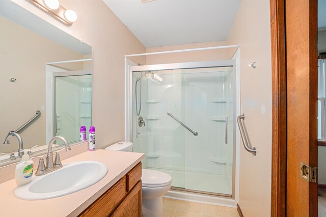 bathroom with vanity, toilet, and walk in shower