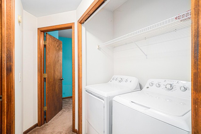 laundry room with carpet flooring and separate washer and dryer