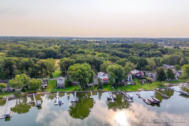 aerial view at dusk featuring a water view