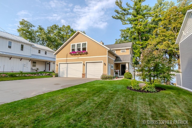 view of front of home with a front yard and a garage