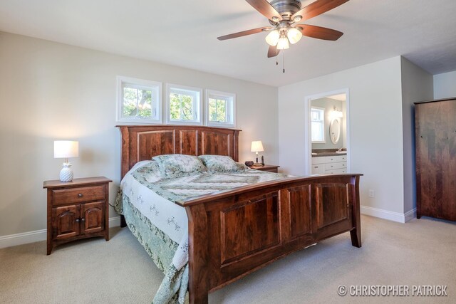 carpeted bedroom with ceiling fan and ensuite bath