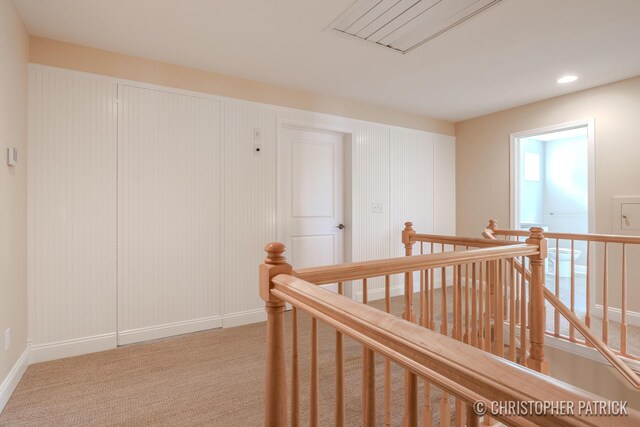 hallway featuring light carpet