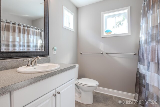 bathroom featuring vanity, toilet, and a shower with curtain