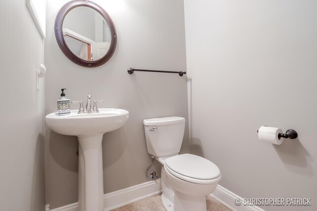 bathroom featuring toilet and tile patterned floors